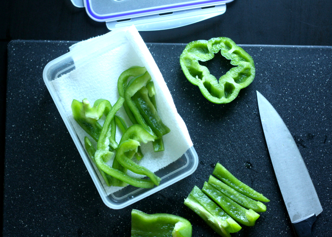 Cutting Board with Knife and Chopped Green Bell Peppers