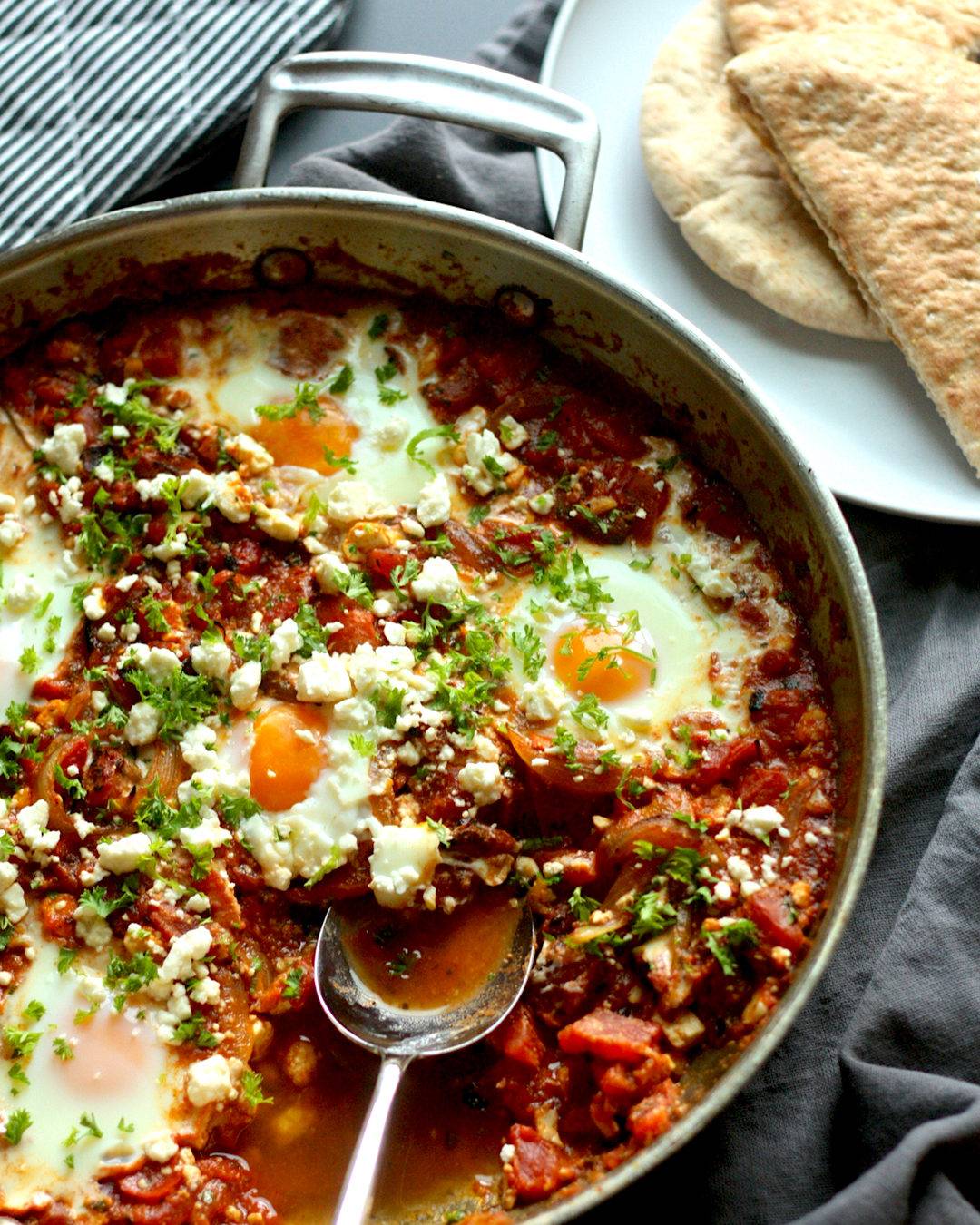 Skillet with Roasted Pepper Shakshuka and Toasted Pita Bread